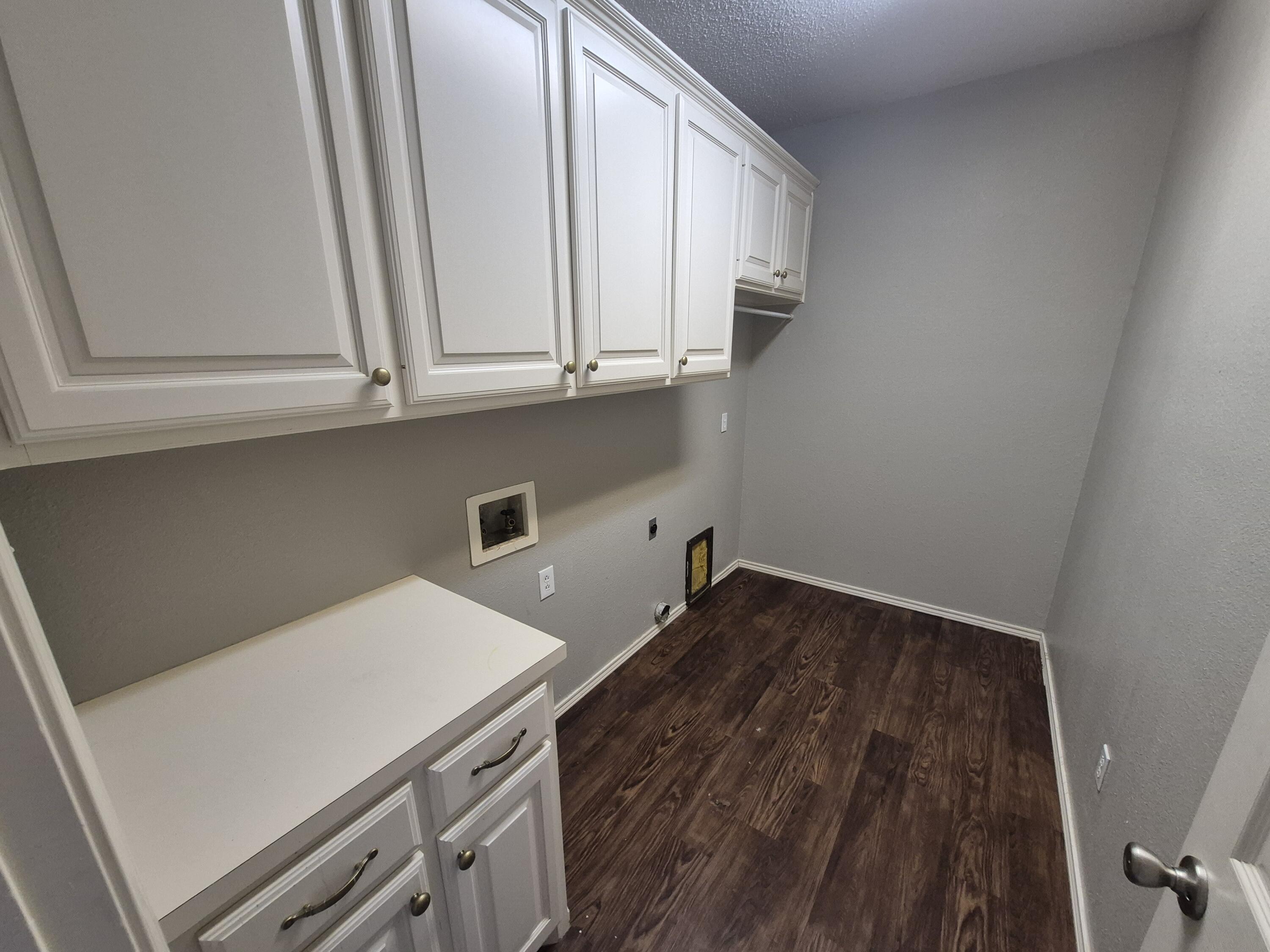 5117 79th Drive Lubbock, TX 79424 - Photo 12 of 35 a view of storage and utility room with washer and dryer