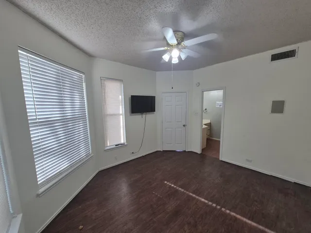 a view of a livingroom with a ceiling fan and window