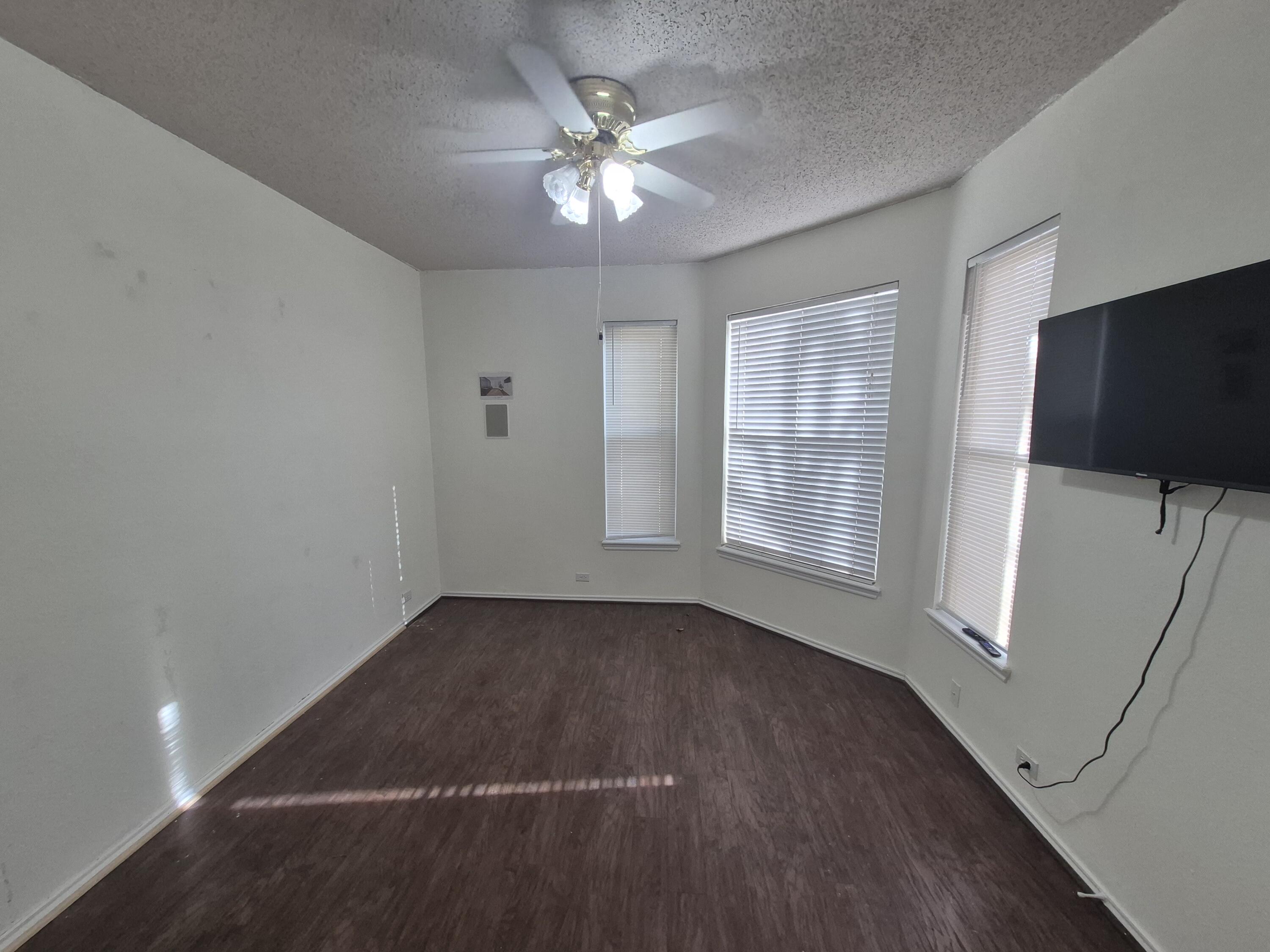 5117 79th Drive Lubbock, TX 79424 - Photo 15 of 35 wooden floor in an empty room with a window
