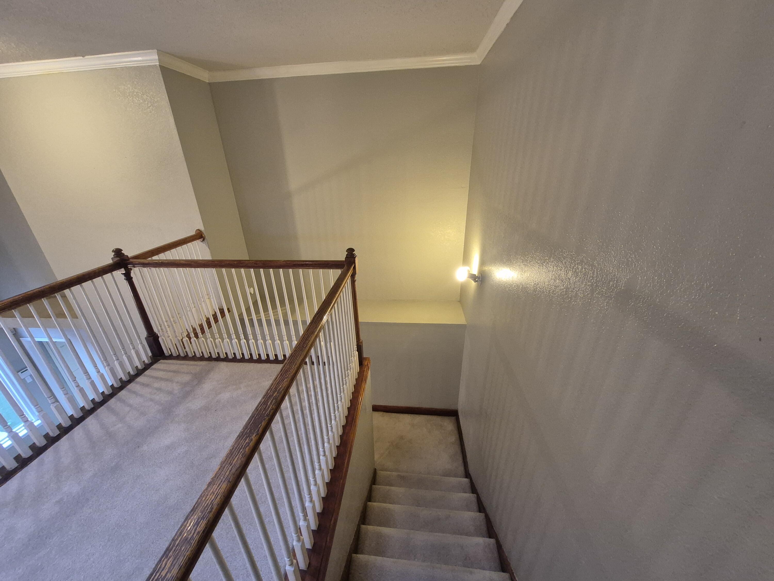 5117 79th Drive Lubbock, TX 79424 - Photo 20 of 35 a view of a hallway with wooden floor and staircase