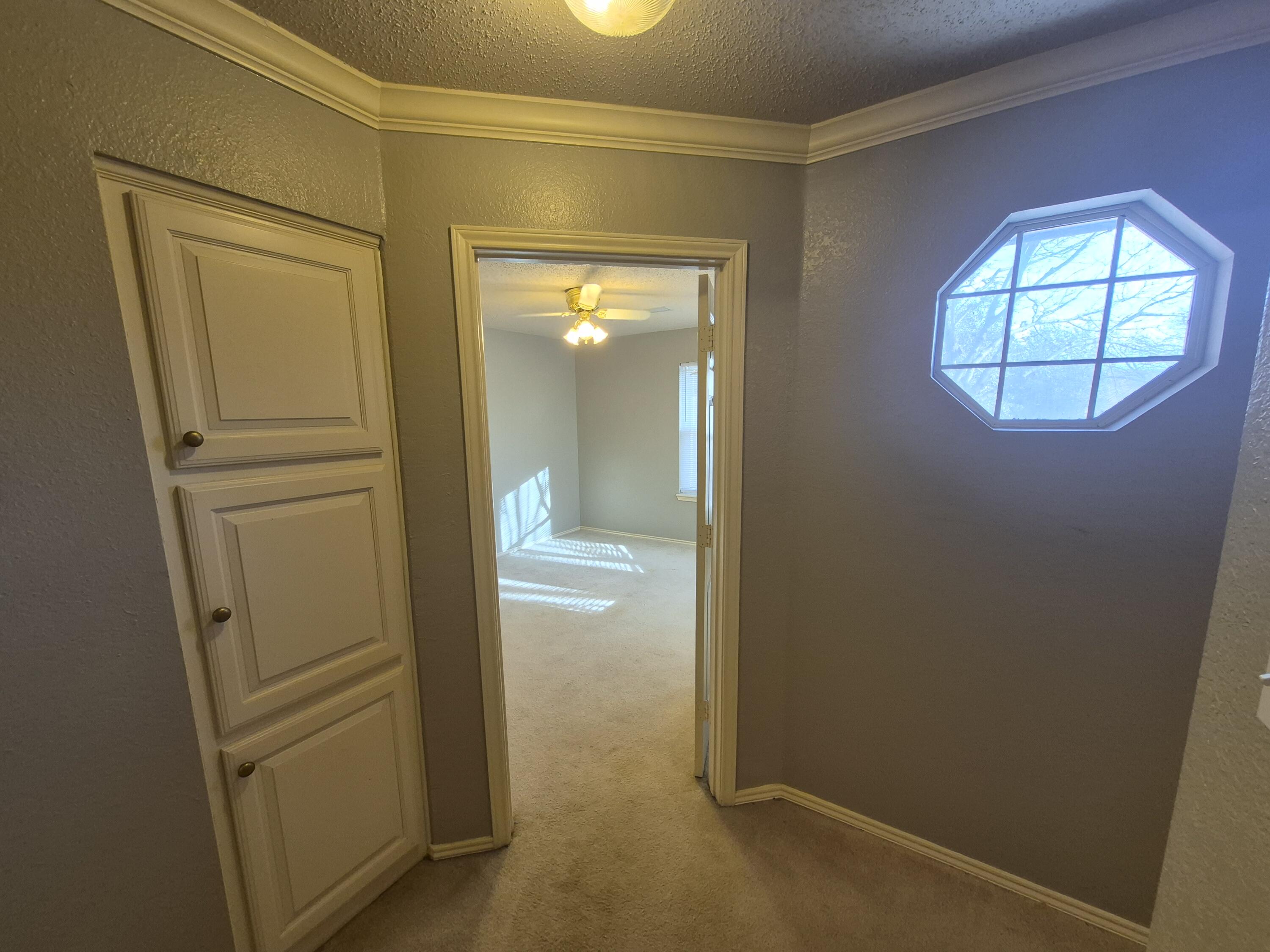 5117 79th Drive Lubbock, TX 79424 - Photo 24 of 35 an empty room with windows and closet