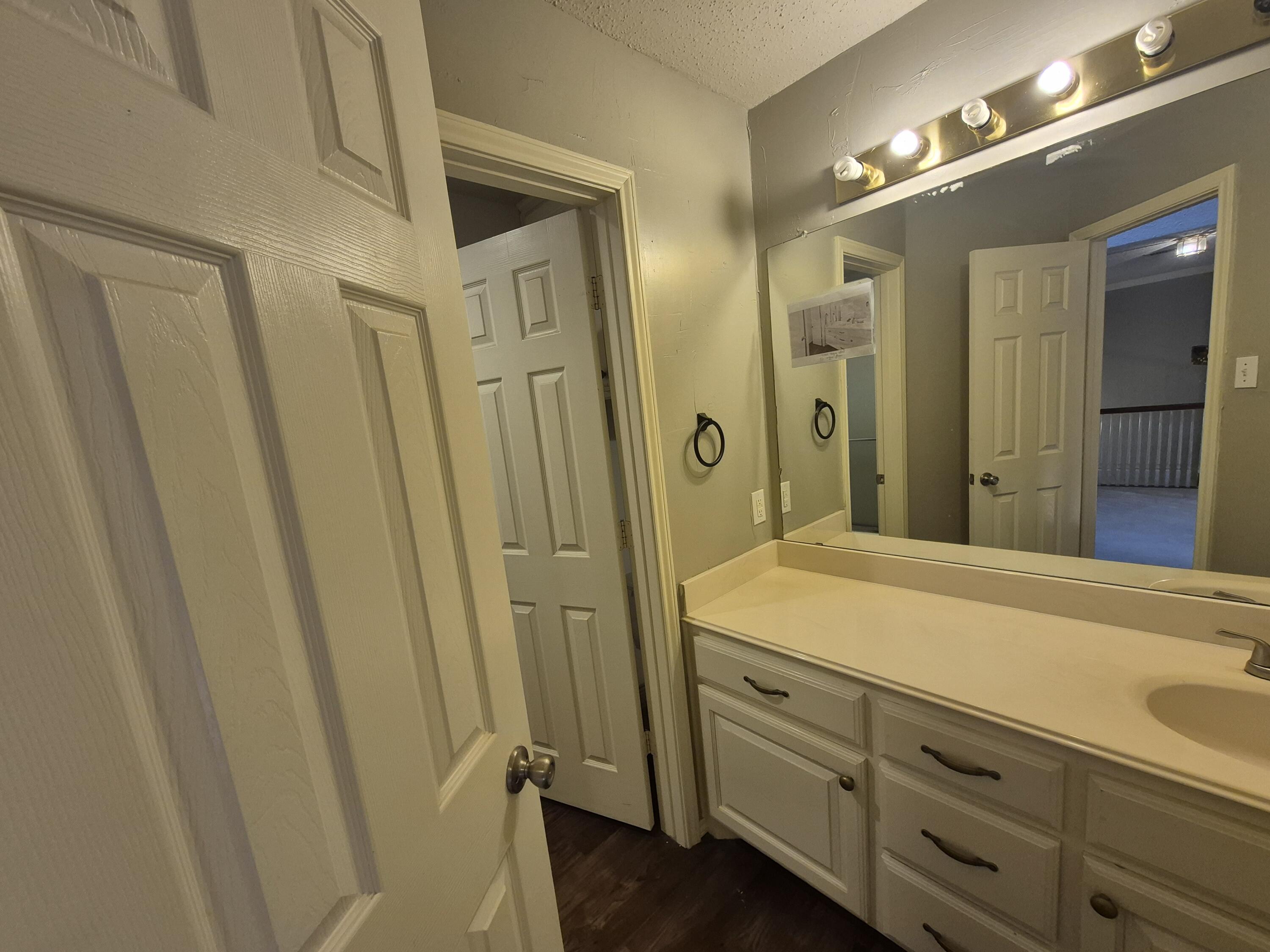 5117 79th Drive Lubbock, TX 79424 - Photo 31 of 35 a bathroom with a sink and a mirror