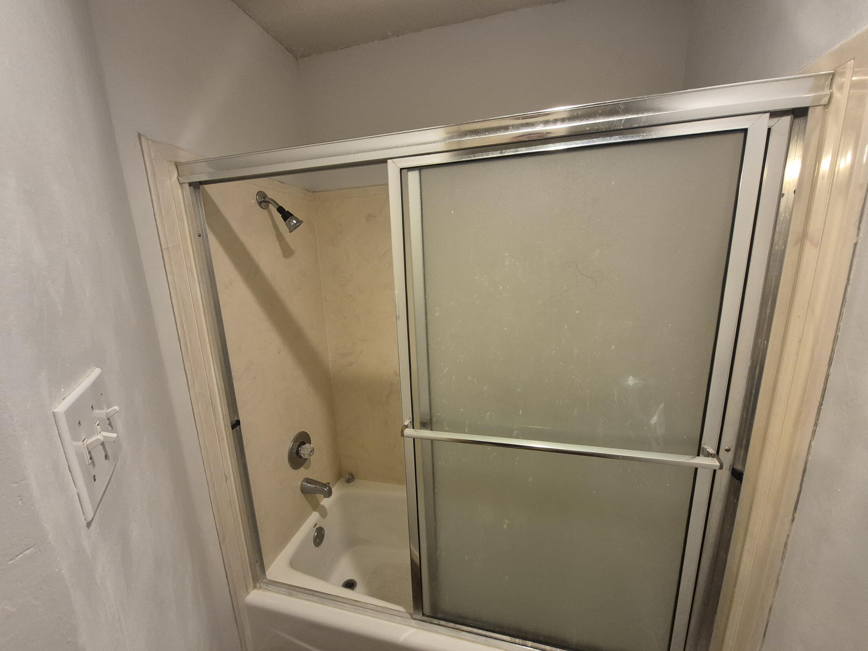 5117 79th Drive Lubbock, TX 79424 - Photo 32 of 35 a bathroom with a glass shower door