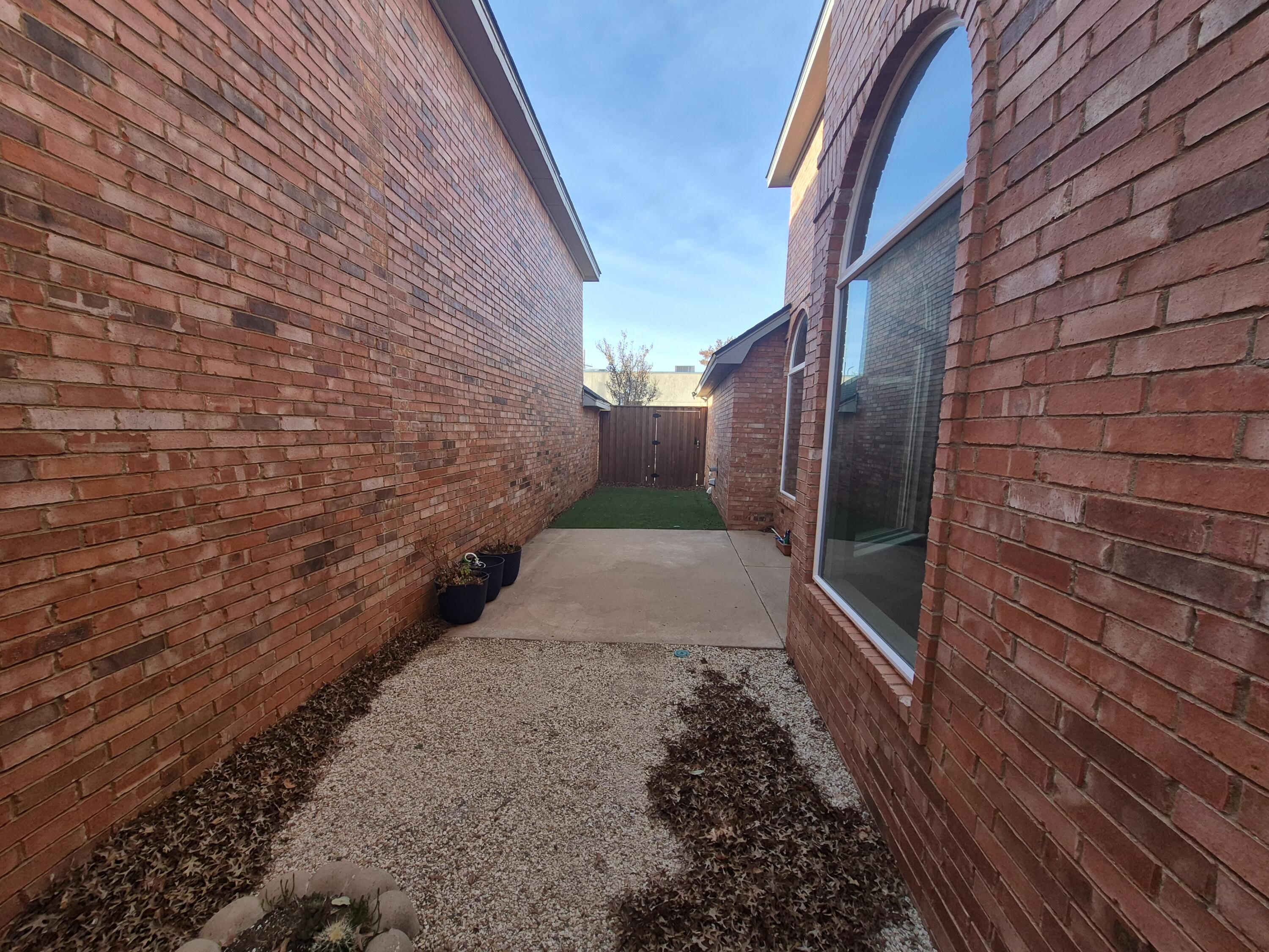 5117 79th Drive Lubbock, TX 79424 - Photo 33 of 35 a pathway of a house with a yard