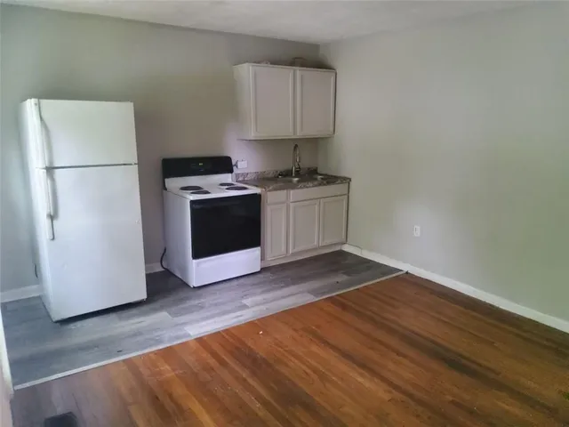 a kitchen with a refrigerator and a stove