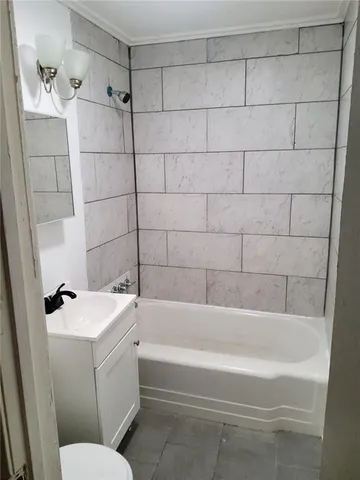 a bathroom with a bathtub and a toilet