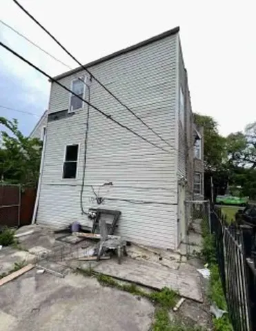 a view of a wooden house and a yard