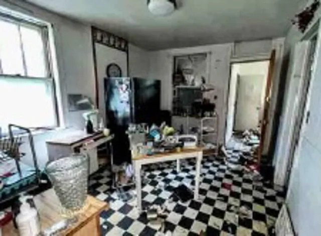 a room with lots of white furniture and a window