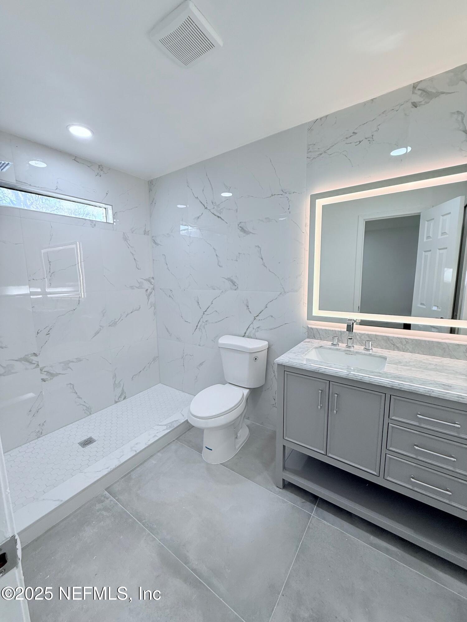 2160 Rothbury Drive Jacksonville, FL 32221 - Photo 17 of 38 a bathroom with a double vanity sink toilet and shower