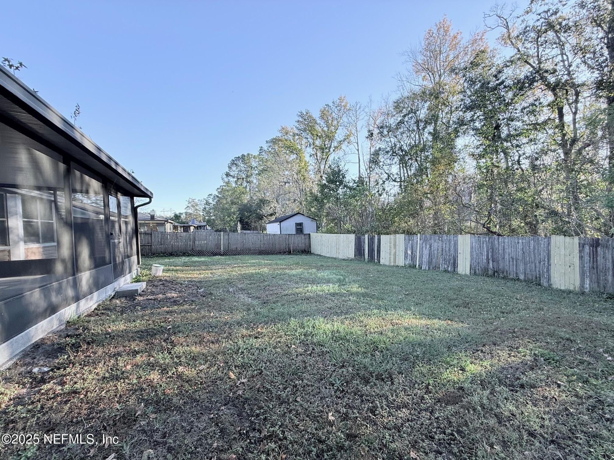 2160 Rothbury Drive Jacksonville, FL 32221 - Photo 32 of 38 a backyard of a house with lots of green space