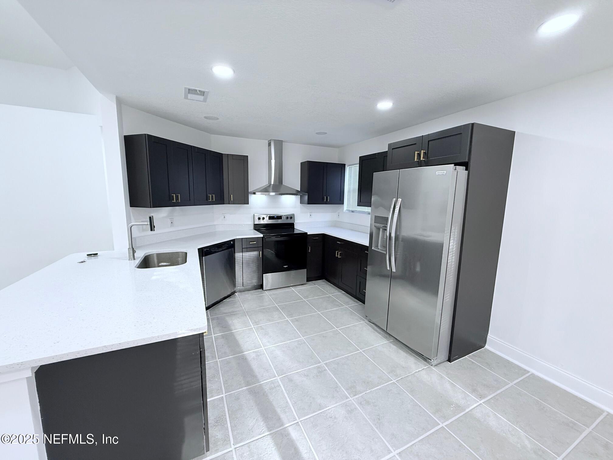 2160 Rothbury Drive Jacksonville, FL 32221 - Photo 8 of 38 a kitchen with stainless steel appliances a refrigerator sink and microwave