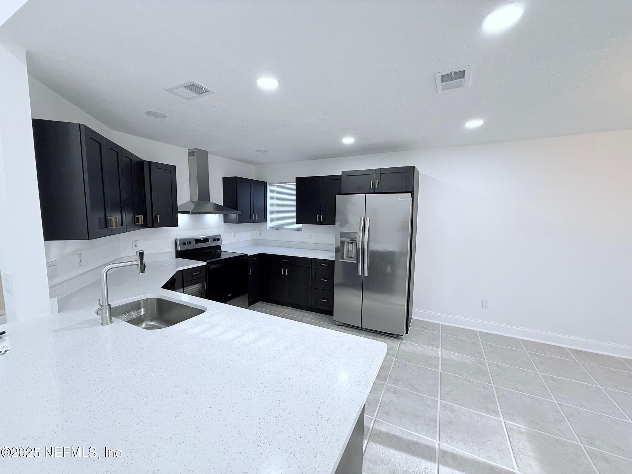 2160 Rothbury Drive Jacksonville, FL 32221 - Photo 9 of 38 a kitchen with stainless steel appliances a refrigerator sink and microwave