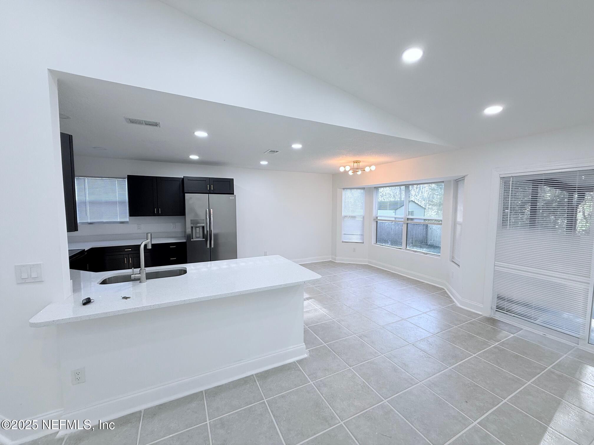 2160 Rothbury Drive Jacksonville, FL 32221 - Photo 10 of 38 a large room with a large window and flat screen tv