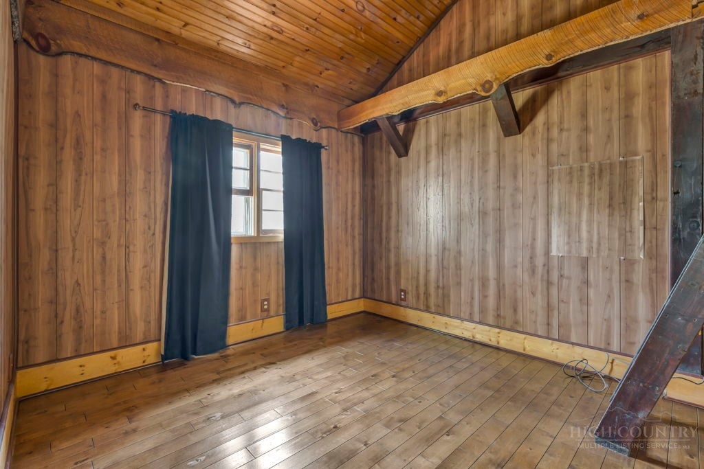 179 Soave Ridge Deep Gap, NC 28618 - Photo 19 of 31 a view of an empty room with wooden floor and a window
