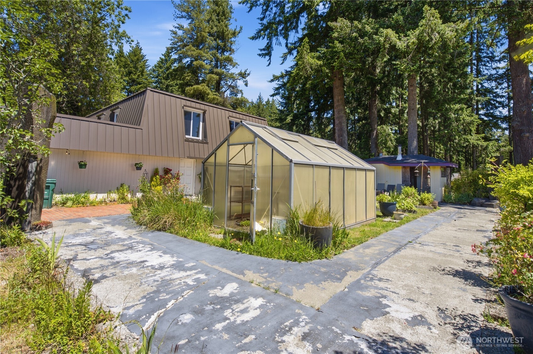 3050 Southeast Mullenix Road Port Orchard, WA 98367 - Photo 33 of 40 a view of a back yard with flower plants