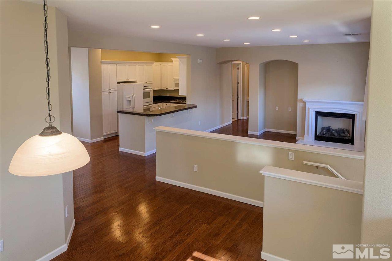 9900 Wilbur May, Unit 3805 Reno, NV 89521 - Photo 3 of 5 a kitchen with kitchen island a counter top space a sink a stove and a refrigerator