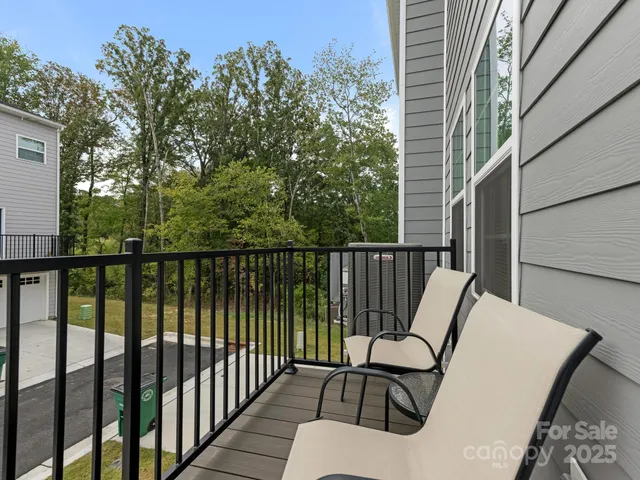 a view of a balcony with wooden floor and fence