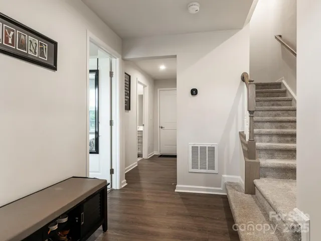 a view of a hallway with wooden floor and entryway