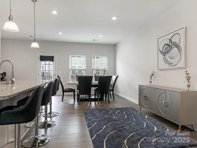 a view of a a dining room with furniture window and wooden floor