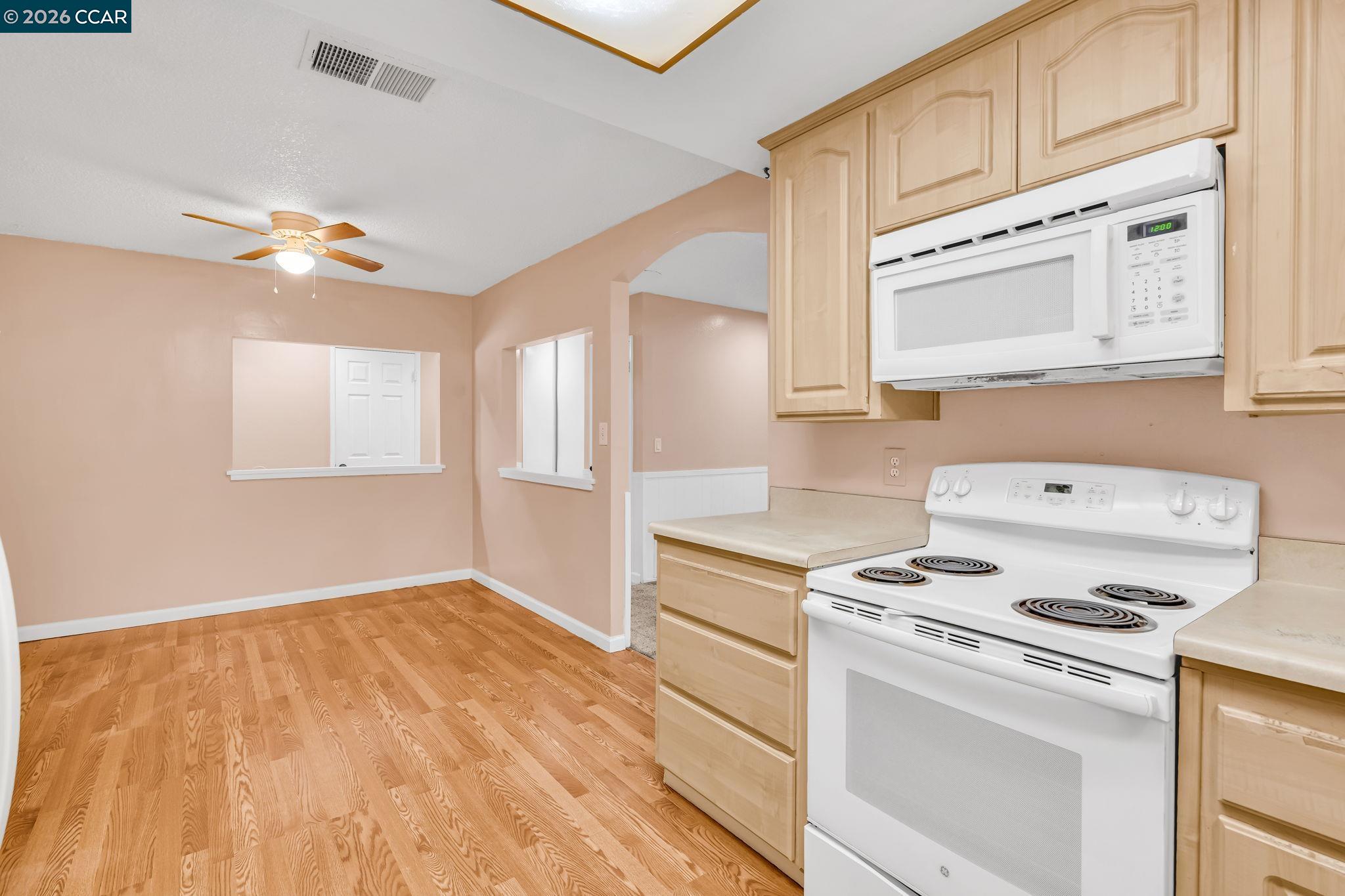 3321 Fraser Road Antioch, CA 94509 - Photo 19 of 46 a kitchen with a stove cabinets and wooden floor