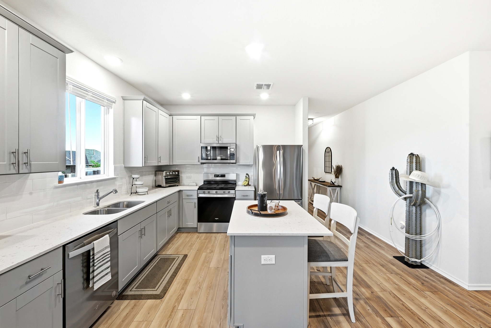 462 Tree Nut Loop Buda, TX 78610 - Photo 14 of 38 Stainless steel appliances are paired with a tile backsplash and quartz countertops for a clean, functional finish
