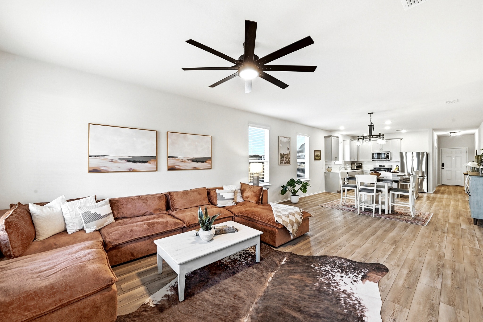 462 Tree Nut Loop Buda, TX 78610 - Photo 2 of 38 The living room is sized for a large sectional and stays connected to the kitchen and dining areas