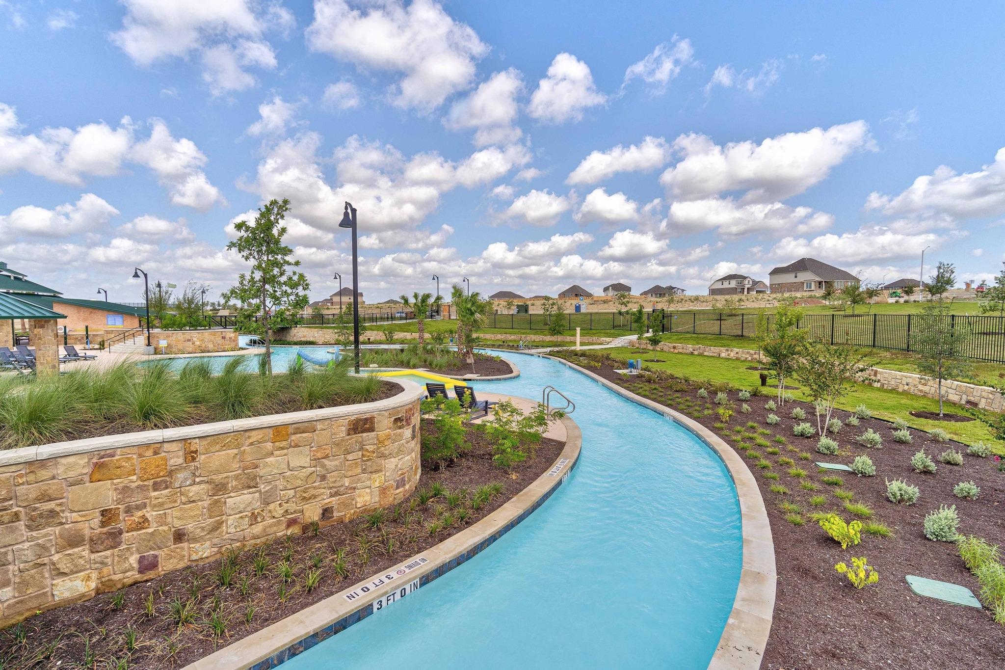 462 Tree Nut Loop Buda, TX 78610 - Photo 29 of 38 Being a Sunfield resident gives you access to this 1,000-foot lazy river and the surrounding water features
