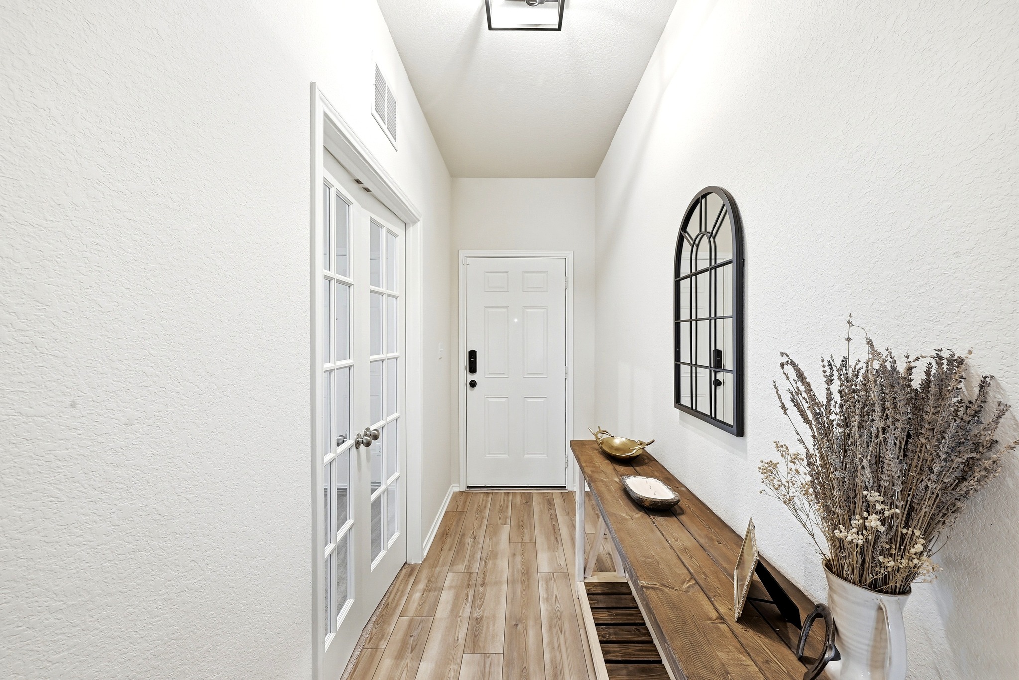 462 Tree Nut Loop Buda, TX 78610 - Photo 9 of 38 The entry features vinyl plank flooring that continues through the kitchen and living area