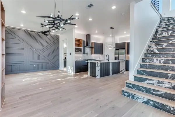 a view of a kitchen with a sink and ceiling fan