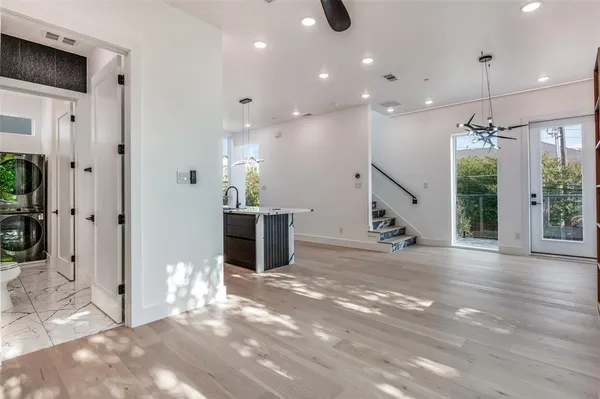 a view of a hallway with wooden floor and staircase