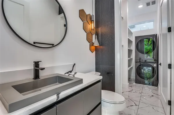 a bathroom with a sink a toilet and a mirror