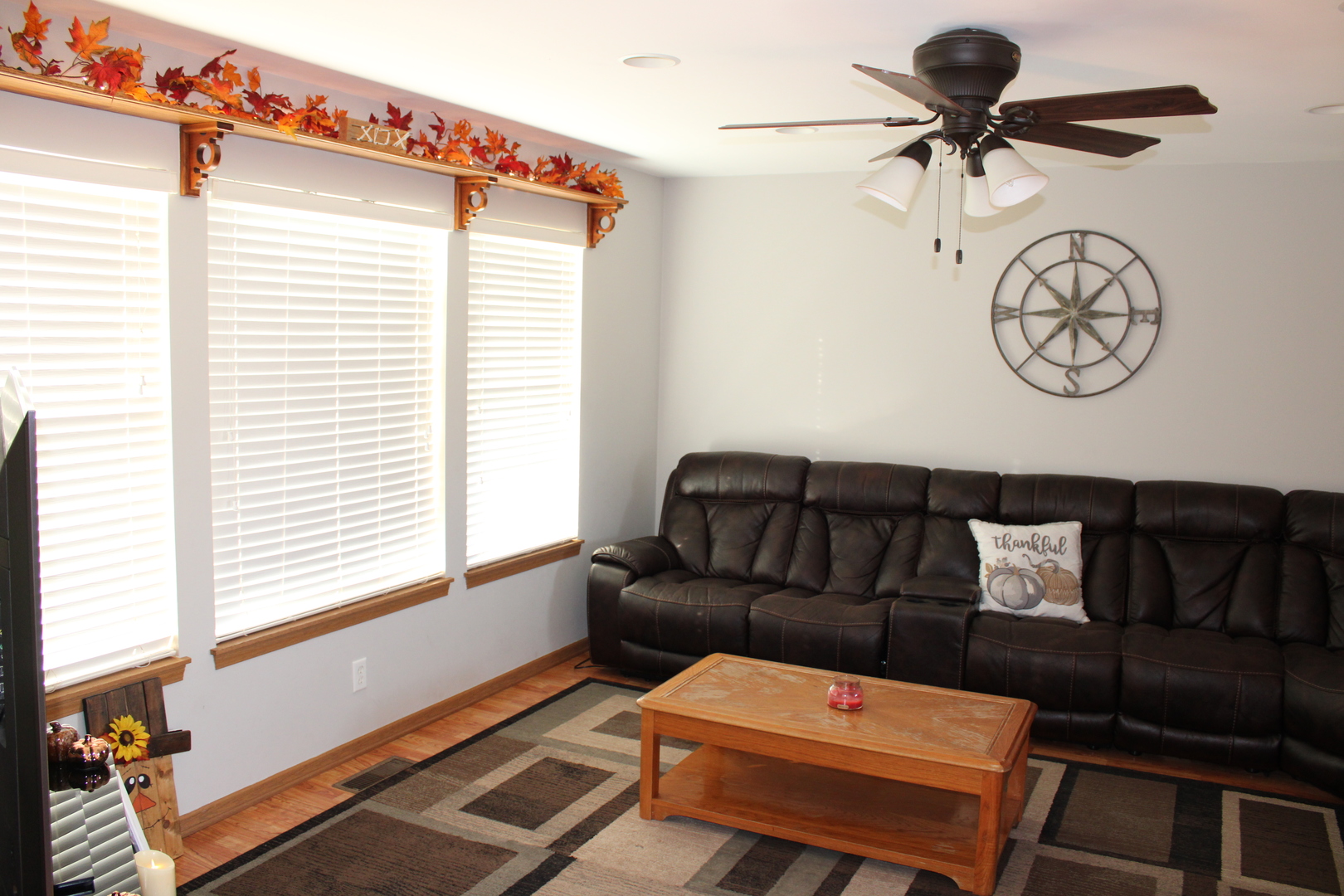 245 Rollin Road, Unit D Somonauk, IL 60552 - Photo 5 of 29 a living room with furniture a clock on wall and a window
