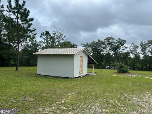 a house with huge green field in front of it