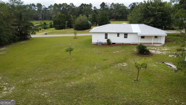 a view of house with garden space and swimming pool