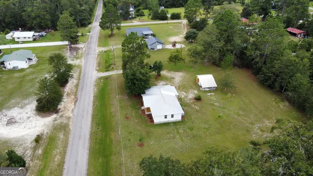 an aerial view of a house with a yard