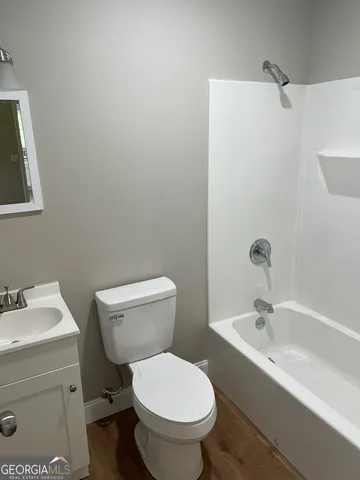 a white toilet sitting next to a bathroom sink