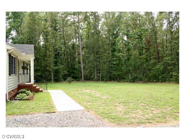 Land/Lot - The 6 Acre property is surrounded by huge old growth hardwoods, but has a large front and back yard cleared around the home.