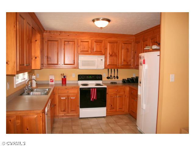 Kitchen - The kitchen features custom raised panel cabinets, tons of cabinet space, and all of the appliances in the home convey!