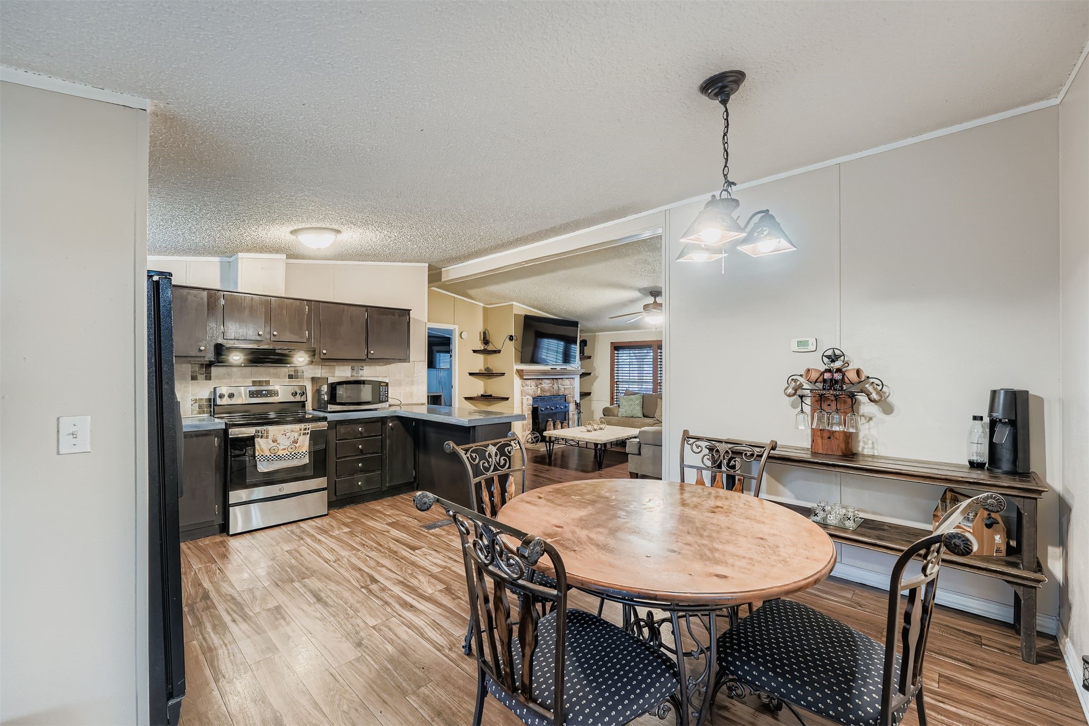 145 Alyssa Loop Bastrop, TX 78602 - Photo 11 of 40 a kitchen with a table and chairs in it