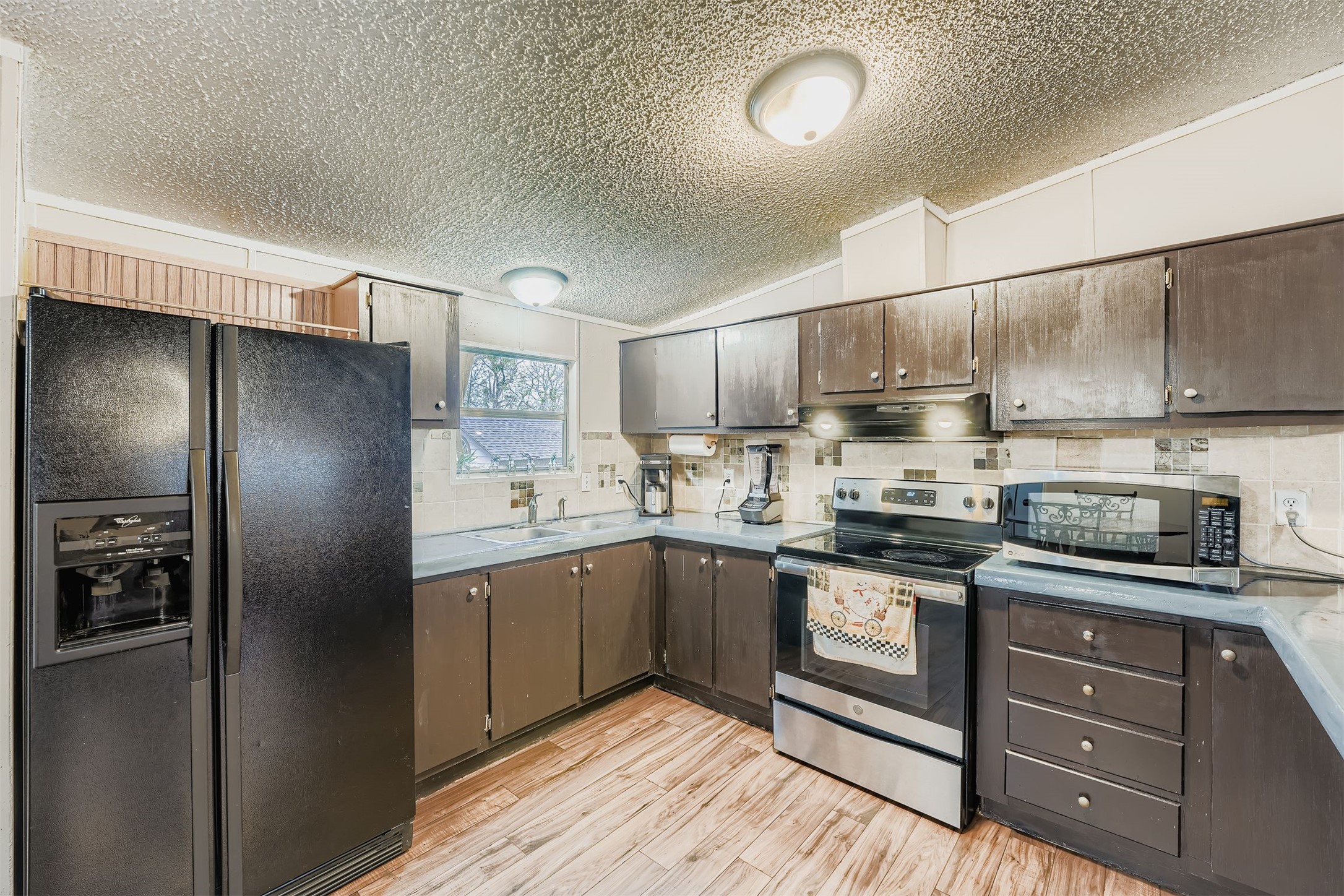 145 Alyssa Loop Bastrop, TX 78602 - Photo 13 of 40 a kitchen with stainless steel appliances granite countertop white cabinets and refrigerator