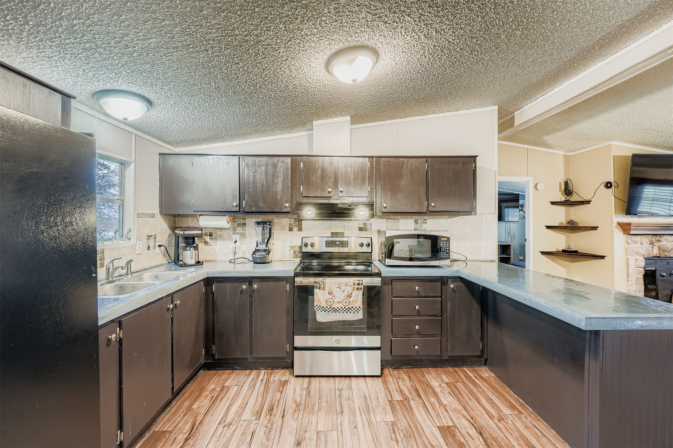 145 Alyssa Loop Bastrop, TX 78602 - Photo 15 of 40 a kitchen with stainless steel appliances granite countertop a sink and cabinets