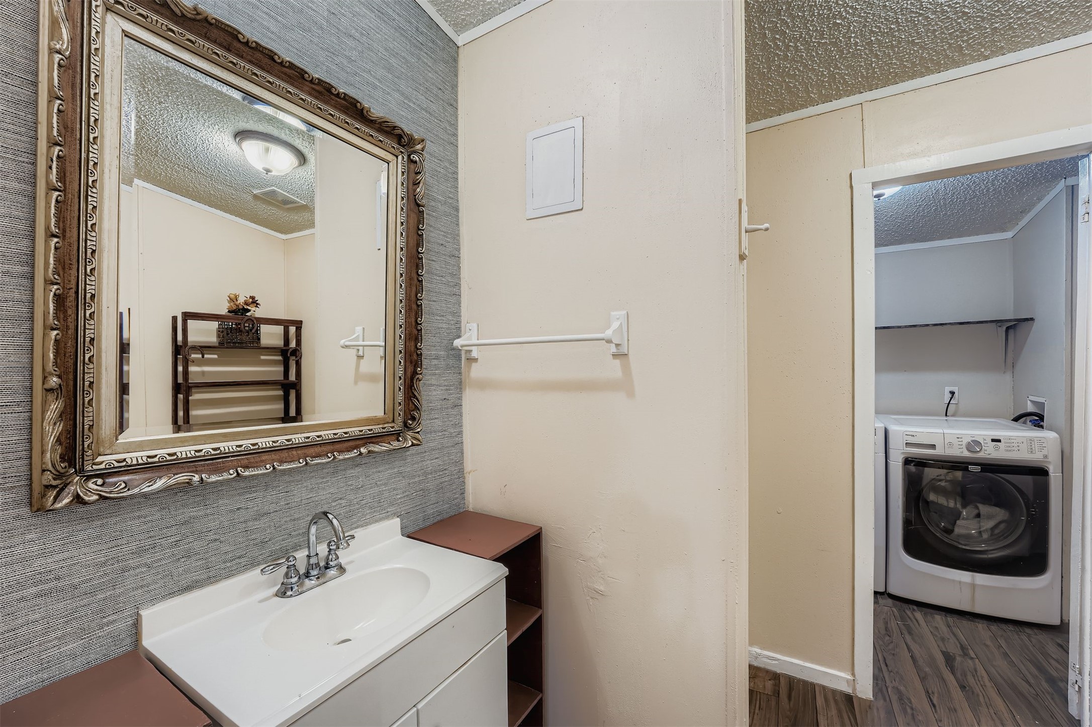 145 Alyssa Loop Bastrop, TX 78602 - Photo 19 of 40 a bathroom with a sink a vanity and mirror