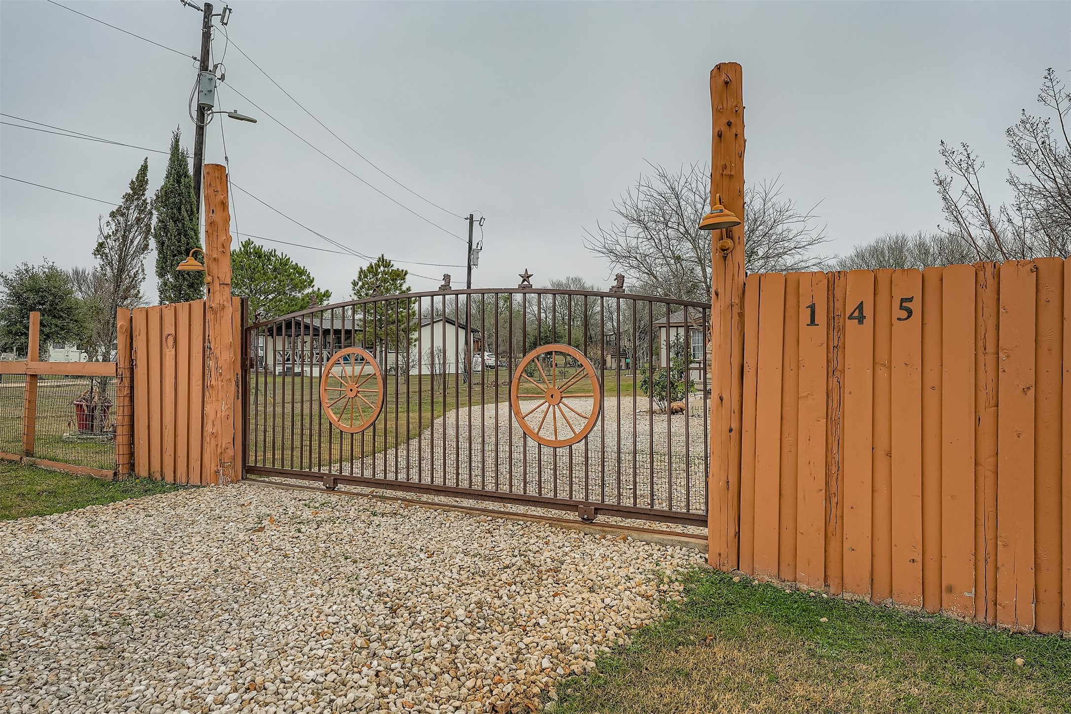 145 Alyssa Loop Bastrop, TX 78602 - Photo 40 of 40 a view of a fence with a sign on the wall