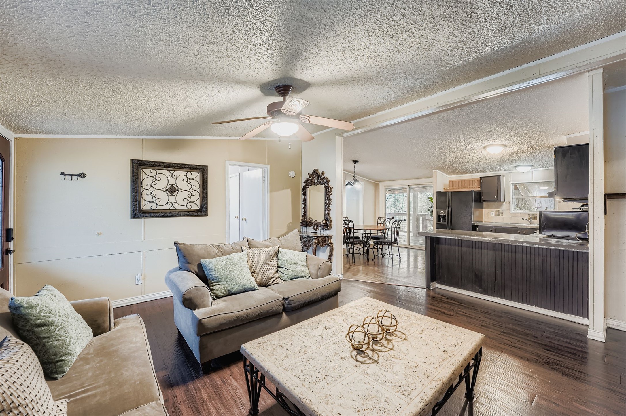 145 Alyssa Loop Bastrop, TX 78602 - Photo 9 of 40 a living room with furniture and kitchen view