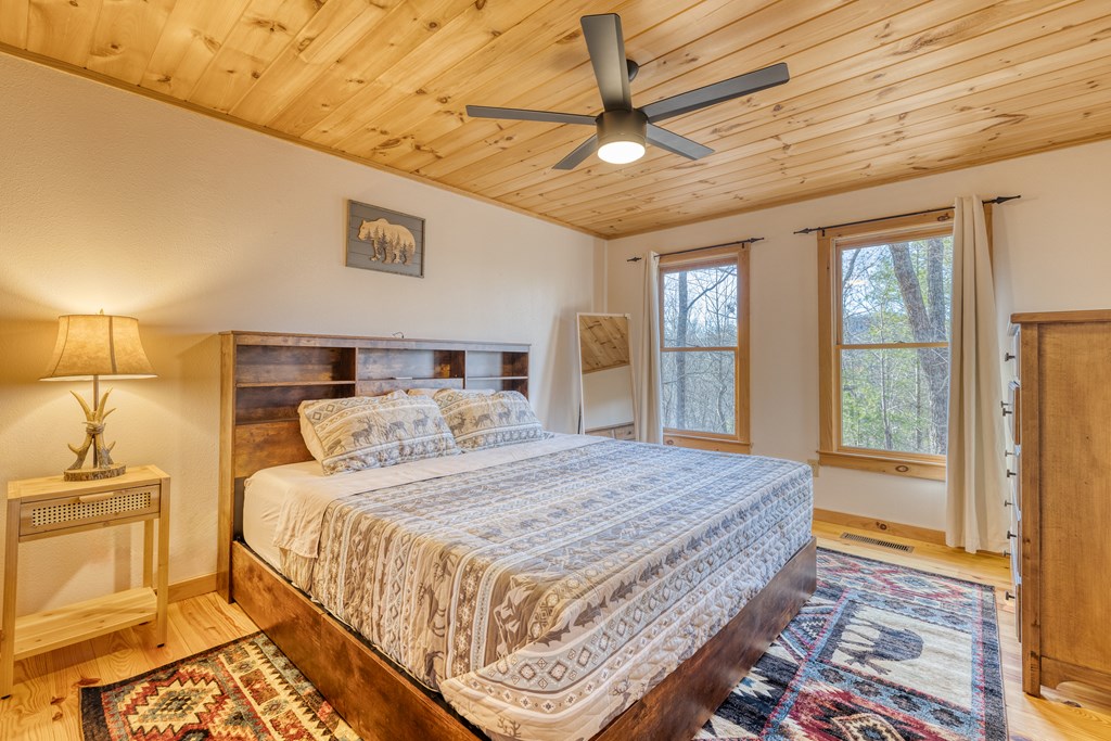 180 Green Ridge Road Blue Ridge, GA 30513 - Photo 13 of 83 a bedroom with a large bed and a window