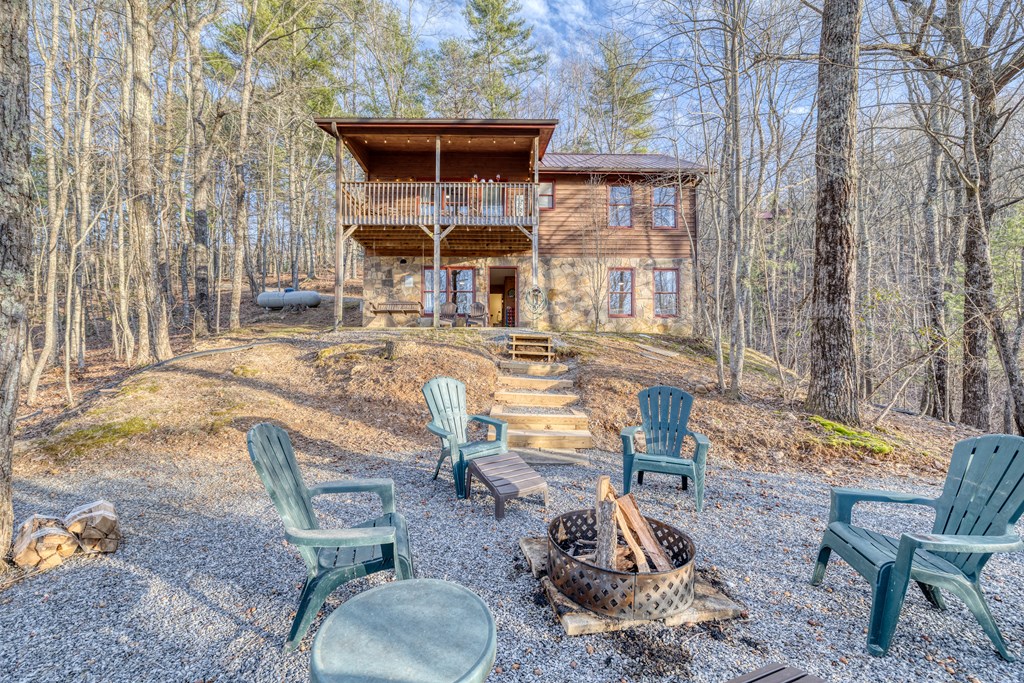 180 Green Ridge Road Blue Ridge, GA 30513 - Photo 58 of 83 a view of a patio with table and chairs with wooden fence and plants