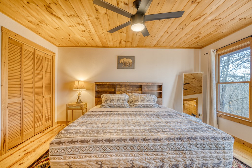 180 Green Ridge Road Blue Ridge, GA 30513 - Photo 60 of 83 a bedroom with a bed and wooden floor