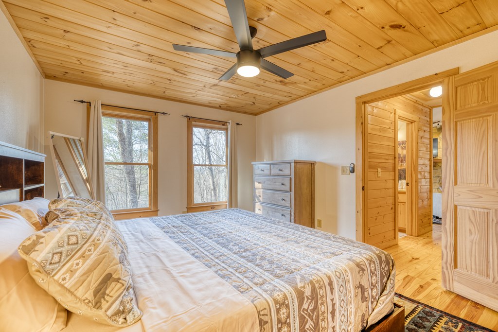 180 Green Ridge Road Blue Ridge, GA 30513 - Photo 72 of 83 a bedroom with a bed next to a window with a bedroom