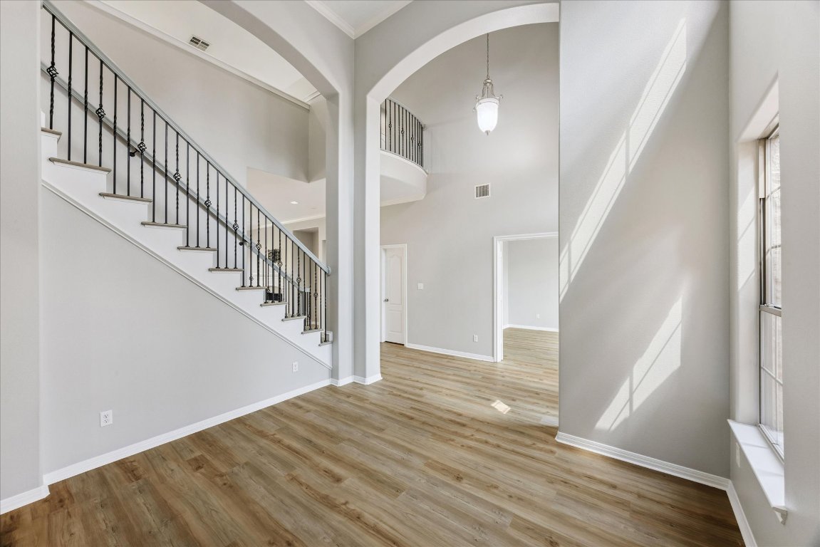 308 Calistoga Court Austin, TX 78732 - Photo 17 of 40 a view of staircase with wooden floor and white walls