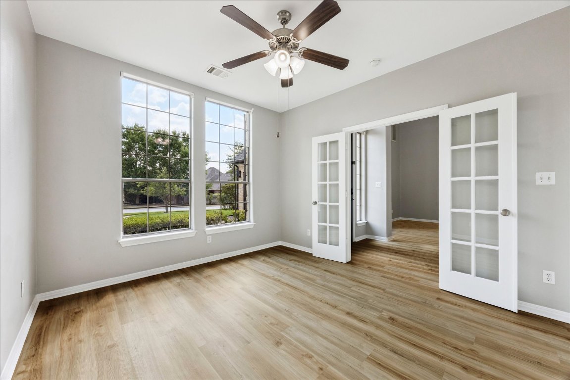 308 Calistoga Court Austin, TX 78732 - Photo 18 of 40 a view of an empty room with a window and wooden floor